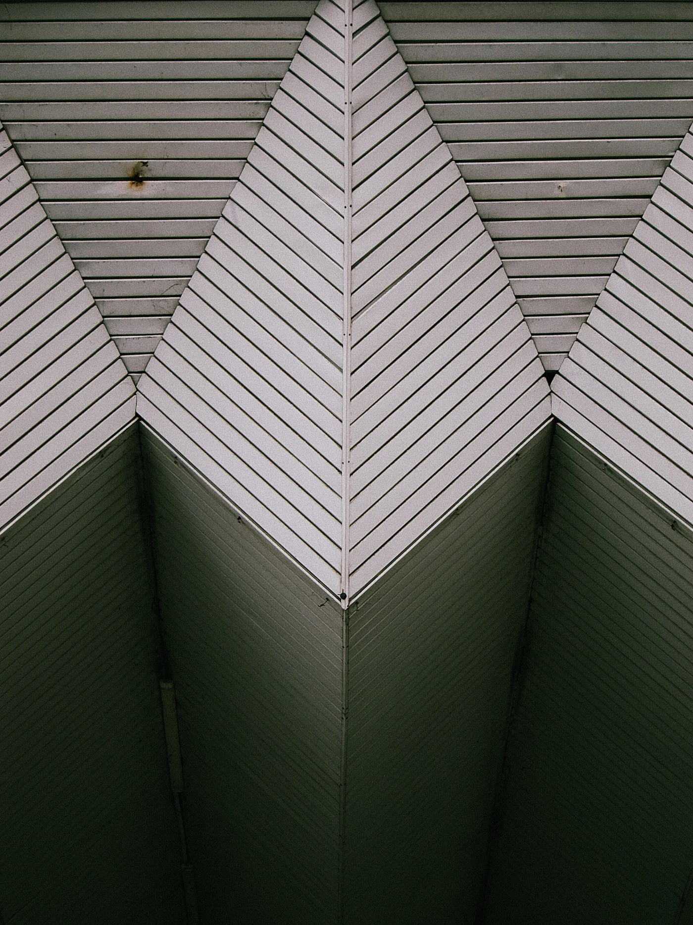 A gray roof with diagonal stripes forming triangular shapes.