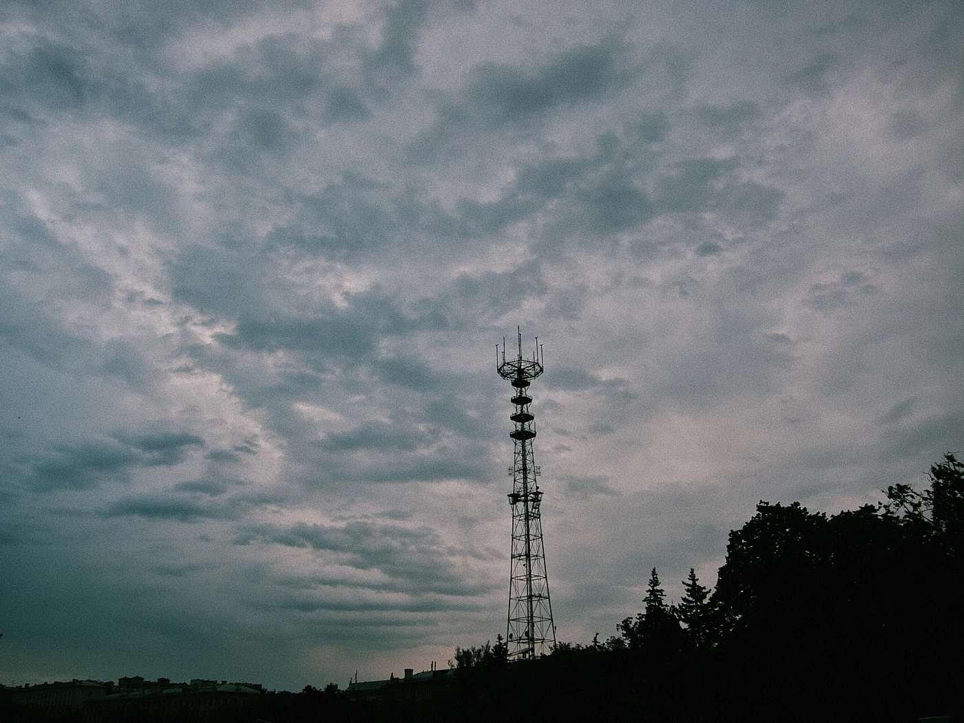 A communications tower against a cloudy sky.
