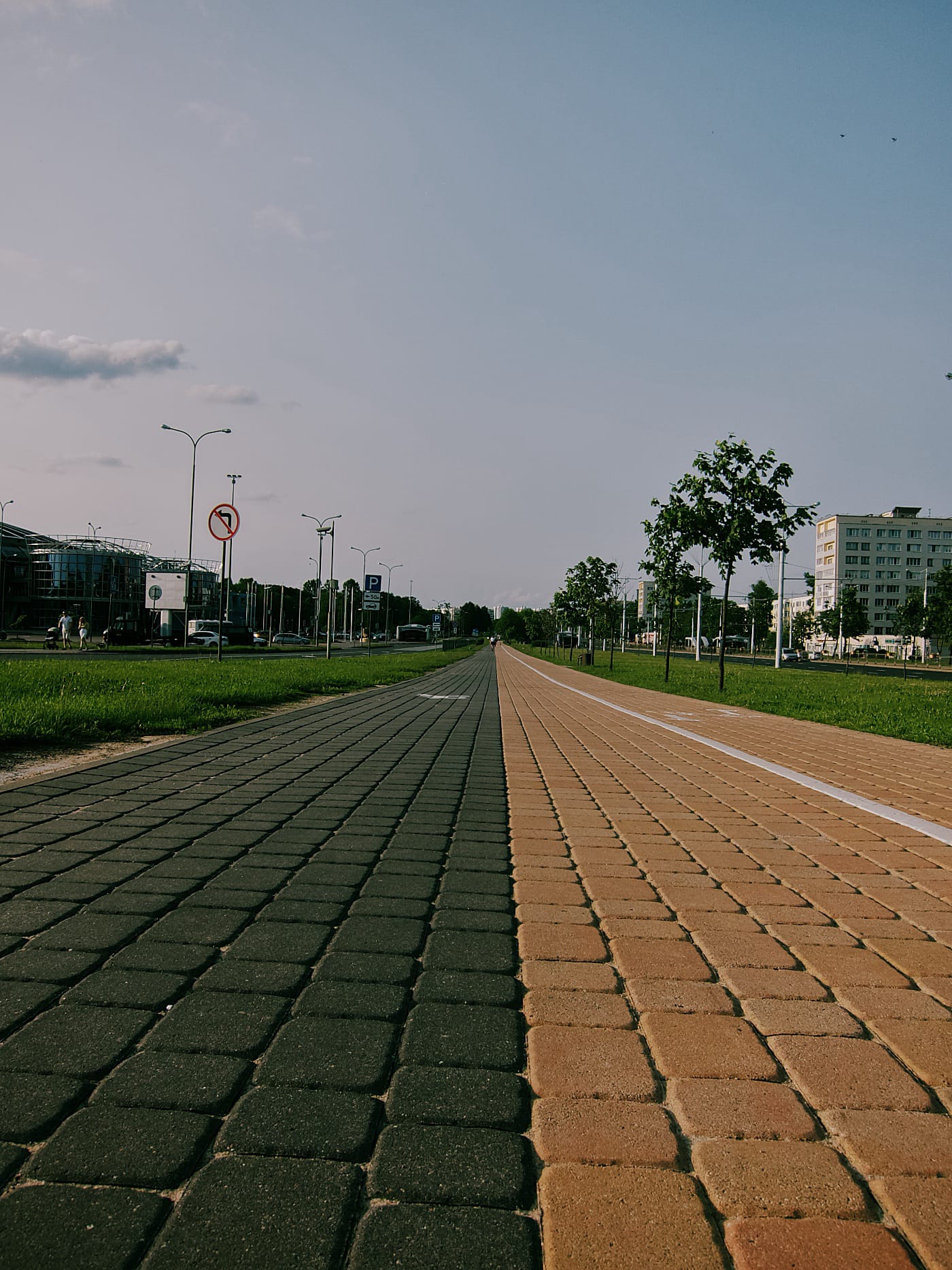 Велосипедная и пешеходная дорожки уходящая вдаль в вечернем городе